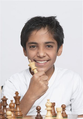 simsearch:630-01491544,k - Portrait of a boy holding a chess piece and smiling Stock Photo - Premium Royalty-Free, Code: 630-01491561