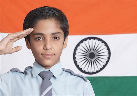 Close-up of a boy saluting in front of the Indian Flag Stock Photo - Premium Royalty-Free, Code: 630-01491571