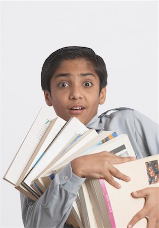 simsearch:630-01491544,k - Portrait of a boy holding books Stock Photo - Premium Royalty-Free, Code: 630-01491573