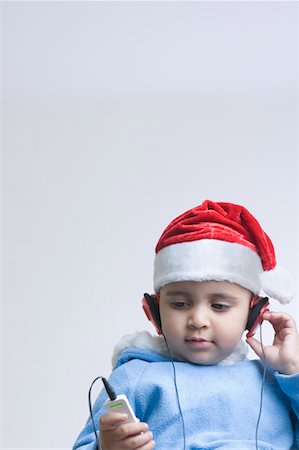 santa children - Close-up of a boy listening to an MP3 player Stock Photo - Premium Royalty-Free, Code: 630-01491583