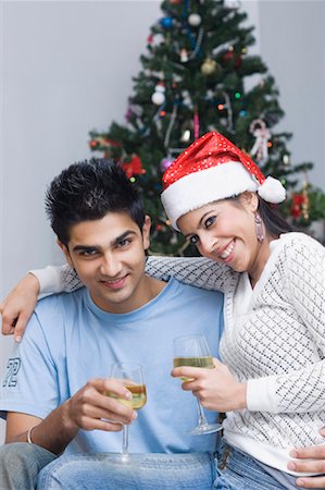 simsearch:649-06716867,k - Portrait of a young couple smiling and holding wine glasses Stock Photo - Premium Royalty-Free, Code: 630-01491645