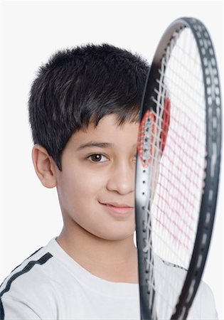 simsearch:630-01491544,k - Portrait of a boy holding a tennis racket in front of his face Stock Photo - Premium Royalty-Free, Code: 630-01491696