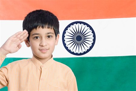 Close-up of a boy saluting in front of the Indian flag Stock Photo - Premium Royalty-Free, Code: 630-01491715