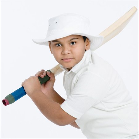 Portrait of a boy holding a cricket bat Stock Photo - Premium Royalty-Free, Code: 630-01491778