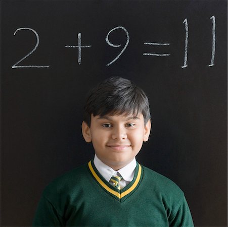simsearch:630-01491544,k - Portrait of a schoolboy smiling in front of a blackboard Stock Photo - Premium Royalty-Free, Code: 630-01491784