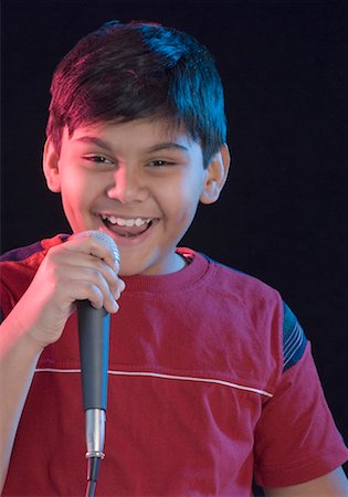 simsearch:630-01491544,k - Portrait of a boy singing and holding a microphone Stock Photo - Premium Royalty-Free, Code: 630-01491790