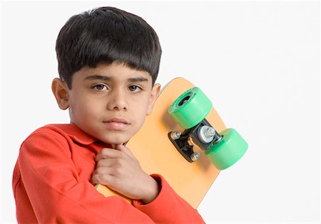 simsearch:630-01491544,k - Portrait of a boy carrying a skateboard Stock Photo - Premium Royalty-Free, Code: 630-01491814