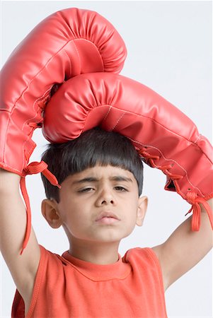simsearch:630-01491544,k - Portrait of a boy wearing boxing gloves and looking sad Stock Photo - Premium Royalty-Free, Code: 630-01491816