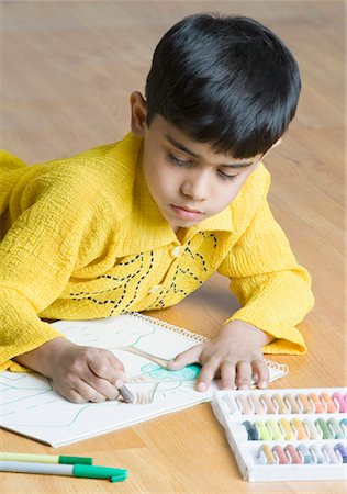 simsearch:630-01491544,k - Boy lying on the hardwood floor and drawing with crayons Stock Photo - Premium Royalty-Free, Code: 630-01491824