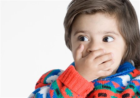 Gros plan d'un garçon couvrant sa bouche avec ses mains Photographie de stock - Premium Libres de Droits, Code: 630-01491918