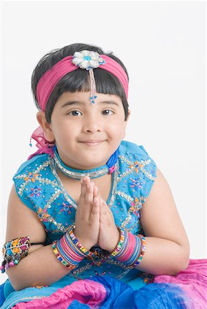 Portrait of a girl wearing traditional clothes and folding her hands Stock Photo - Premium Royalty-Free, Code: 630-01492197