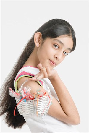 Portrait of a girl holding a basket of candy Stock Photo - Premium Royalty-Free, Code: 630-01492251