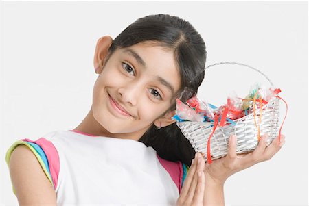 Portrait of a girl holding a basket of candy Stock Photo - Premium Royalty-Free, Code: 630-01492252