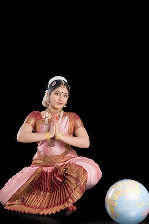 person full body shot crouching - Portrait of a young woman performing Bharatnatyam Stock Photo - Premium Royalty-Free, Code: 630-01492365