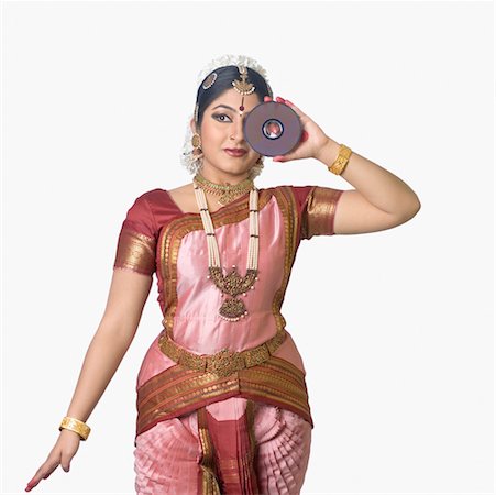 Young woman performing Bharatnatyam and holding a CD Stock Photo - Premium Royalty-Free, Code: 630-01492373