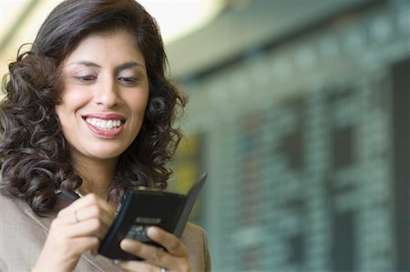 Close-up of a businesswoman writing on a passport Stock Photo - Premium Royalty-Free, Code: 630-01492847