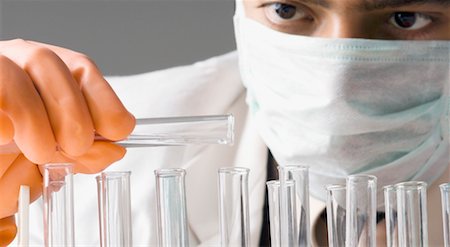 Close-up of a male scientist performing an experiment in a laboratory Stock Photo - Premium Royalty-Free, Code: 630-01493128