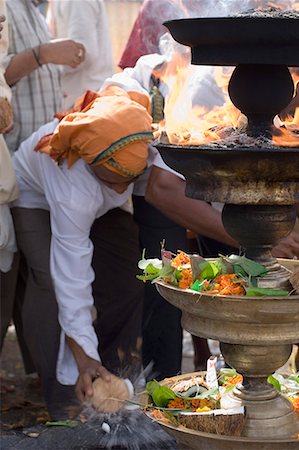 simsearch:400-06071678,k - Man making a religious offering of coconut, Tirupati, Tirumala Venkateswara Temple, Tirumala, Andhra Pradesh, India Stock Photo - Premium Royalty-Free, Code: 630-01707706