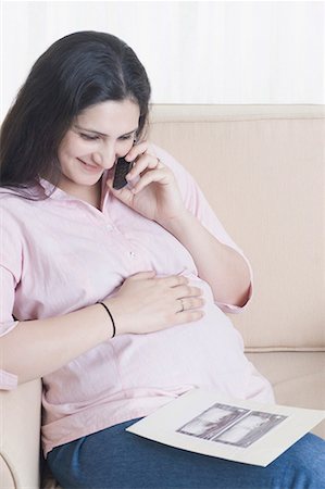 Close-up of a pregnant woman talking on a mobile phone Stock Photo - Premium Royalty-Free, Code: 630-01708209