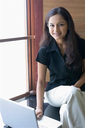 Portrait d'une femme d'affaires à l'aide d'un ordinateur portable dans une chambre d'hôtel Photographie de stock - Premium Libres de Droits, Code: 630-01708439