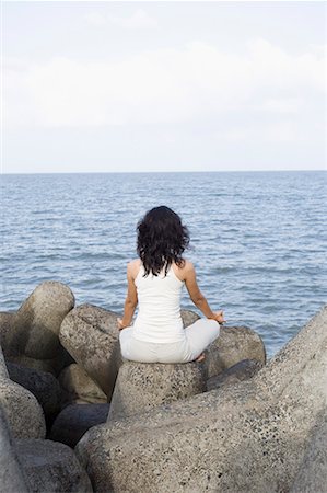 simsearch:640-03265635,k - Rear view of a young woman doing yoga on rocks Stock Photo - Premium Royalty-Free, Code: 630-01708714