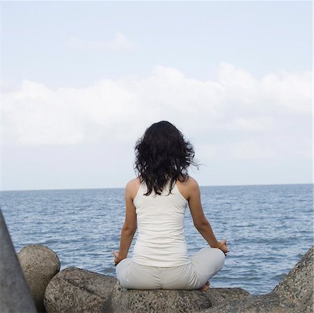 simsearch:640-03265635,k - Rear view of a young woman doing yoga on rocks Stock Photo - Premium Royalty-Free, Code: 630-01708715