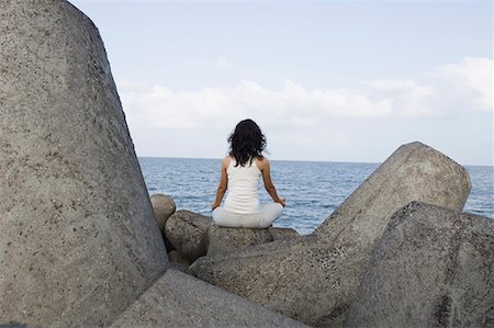 simsearch:640-03265635,k - Rear view of a young woman doing yoga on a rock Stock Photo - Premium Royalty-Free, Code: 630-01708716
