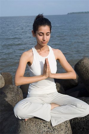 full woman body pose - Young woman doing yoga on a rock Stock Photo - Premium Royalty-Free, Code: 630-01708731