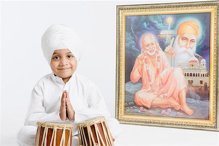 praying position - Portrait of a boy sitting in front of bongo and praying Stock Photo - Premium Royalty-Free, Code: 630-01708790