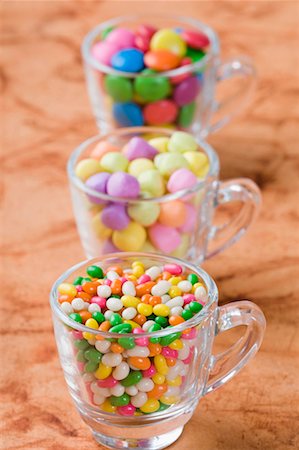 Row of three cups filled with jellybeans and candies Stock Photo - Premium Royalty-Free, Code: 630-01709483