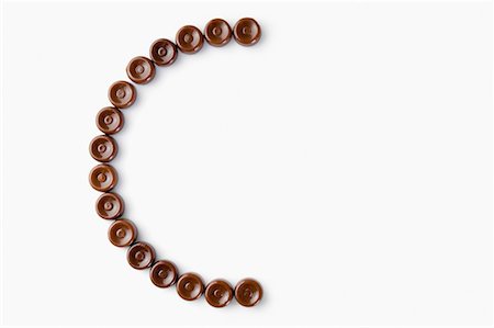 simsearch:630-01709492,k - High angle view of brown candies arranged in the form of letter c Stock Photo - Premium Royalty-Free, Code: 630-01709513