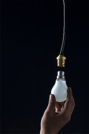 Close-up of a person's hand holding a light bulb Stock Photo - Premium Royalty-Free, Code: 630-01709844
