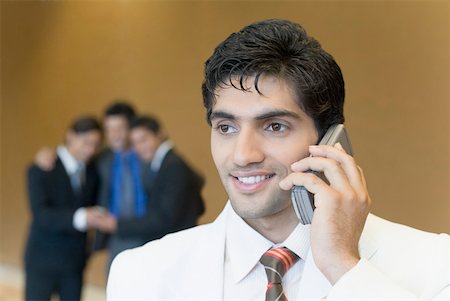 simsearch:630-01873072,k - Close-up of a businessman talking on a mobile phone and smiling Stock Photo - Premium Royalty-Free, Code: 630-01874018