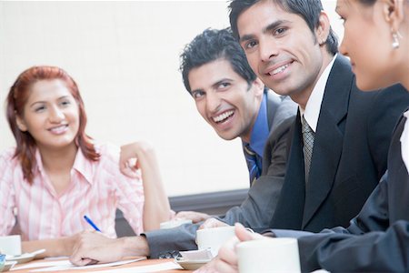 simsearch:630-01873072,k - Business executives smiling in a conference room Stock Photo - Premium Royalty-Free, Code: 630-01874082