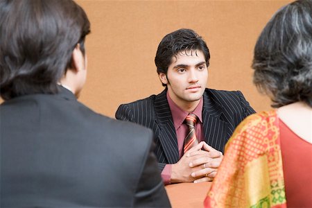 simsearch:655-03458001,k - Businessman discussing with two business executives in a meeting Stock Photo - Premium Royalty-Free, Code: 630-01874138