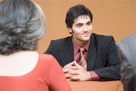 simsearch:655-03458001,k - Businessman discussing with two business executives in a meeting Stock Photo - Premium Royalty-Free, Code: 630-01874139