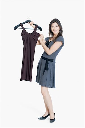 small business portrait full body - Portrait of a young woman holding a dress and smiling Stock Photo - Premium Royalty-Free, Code: 630-01874368
