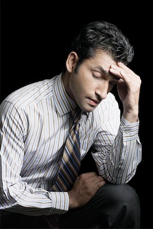 Close-up of a businessman suffering from a headache Stock Photo - Premium Royalty-Free, Code: 630-01874458