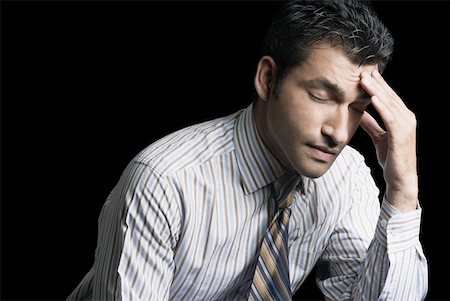 Close-up of a businessman suffering from a headache Stock Photo - Premium Royalty-Free, Code: 630-01874459