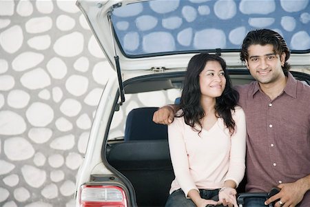 simsearch:630-01296756,k - Young couple sitting in a car trunk and smiling Foto de stock - Sin royalties Premium, Código: 630-01874784