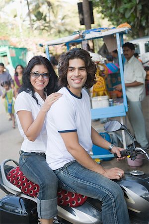 Young couple sitting on a motorcycle Stock Photo - Premium Royalty-Free, Code: 630-01875005