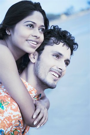 friends piggyback beach - Close-up of a young woman riding piggyback on a young man and smiling Stock Photo - Premium Royalty-Free, Code: 630-01875166