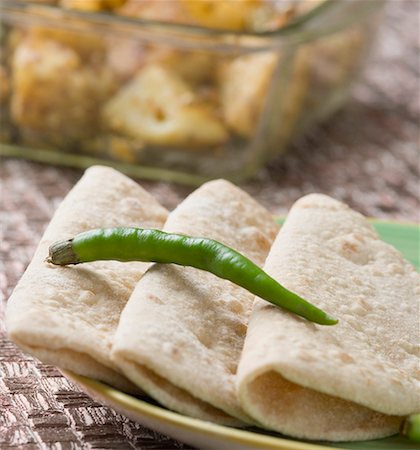 Close-up of chapattis in a plate Stock Photo - Premium Royalty-Free, Code: 630-01875648