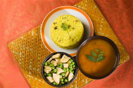 south - High angle view of pulao in a plate with bowl of curries Stock Photo - Premium Royalty-Free, Code: 630-01875677