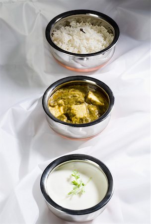 High angle view of three bowls of shahi paneer with curd and rice Stock Photo - Premium Royalty-Free, Code: 630-01875689