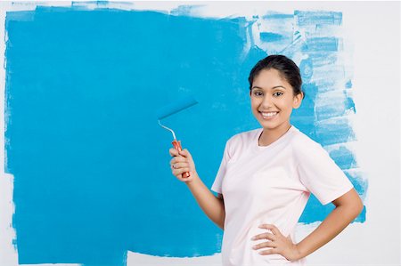 do - Portrait of a young woman painting a wall and smiling Stock Photo - Premium Royalty-Free, Code: 630-01875878