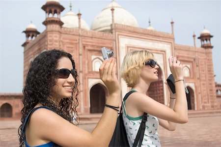 simsearch:630-01876693,k - Side profile of two young women taking a picture in front of a mausoleum, Taj Mahal, Agra, Uttar Pradesh, India Stock Photo - Premium Royalty-Free, Code: 630-01876276