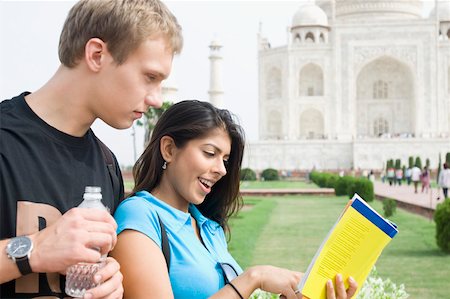 simsearch:630-01876693,k - Close-up of a young couple reading a guidebook in front of a mausoleum, Taj Mahal, Agra, Uttar Pradesh, India Stock Photo - Premium Royalty-Free, Code: 630-01876270