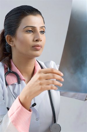 shoulder xray - Close-up of a female doctor examining an X-Ray report Stock Photo - Premium Royalty-Free, Code: 630-01876403