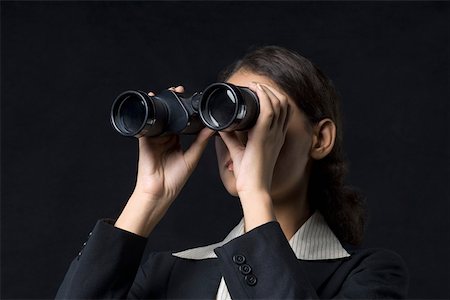 Close-up of a businesswoman looking through binoculars Stock Photo - Premium Royalty-Free, Code: 630-01876498
